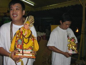 Devotees carry statues of dieties during the fire walking festivals