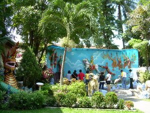 Fish Pond and huge Buddha mural at back garden in Penang Burmese temple