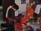 Man being blessed in Dhammikarama Temple Man being blessed in Dhammikarama Temple