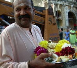 Devotee receiving his offering after prayer to Lord Muruga Devotee receiving his offering after prayer to Lord Muruga