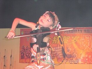 Young enthusiastic violinist during chap goh meh in Penang Young enthusiastic violinist during chap goh meh in Penang