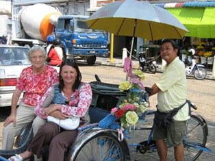 Trishaw Man Mr Lau is Norah and Helen's choice for a leisurely ride around Georgetown Penang Trishaw Man Mr Lau is Norah and Helen's choice for a leisurely ride around Georgetown Penang