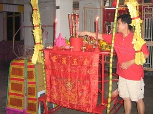 Head of family lighting the first joss stick Head of family lighting the first joss stick