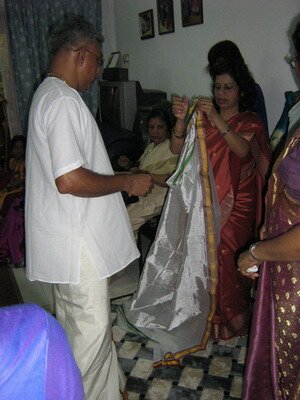 Preparing the head gear for the bride's father in Malaysian Indian Engagement