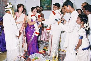 Newly engaged couple exchanging ring in Malaysian Indian Engagement