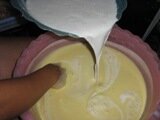 Alternate sugar and santan blending it equally for kuih kapit
