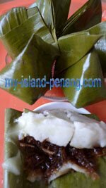 Kuih Koci santan, sweet steamed cakes wrapped in banana leaves Kuih Koci santan, sweet steamed cakes wrapped in banana leaves