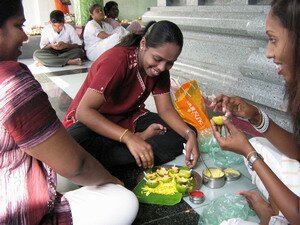 Ladies preparing oil lamps for pujas prayer in Sri Mariamman Temple Penang