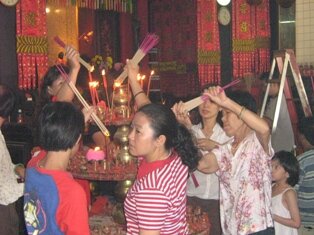 Praying in front of Goddess of Mercy statue