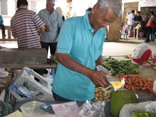 Day in the wet market, our Malay man job selling their fresh herbs conversing in Hokkien Day in the wet market, our Malay man job selling their fresh herbs conversing in Hokkien