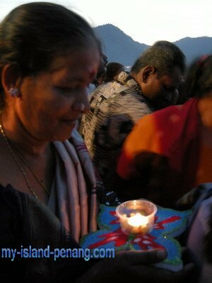 Devotees with lighted styrofoam dish Devotees with lighted styrofoam dish