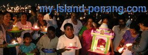 A family of devotees with lighted dish in Chariot Procession Teluk Bahang Penang A family of devotees with lighted dish in Chariot Procession Teluk Bahang Penang
