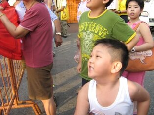 Boy throwing oranges during chap goh meh in penang Boy throwing oranges during chap goh meh in penang