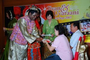 Offering tea to Mr and Mrs Richard Kee, See Koo and Kim 
