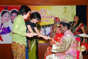 Being offered tea by niece Kok Lin