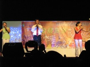 A trio giving a chinese poetic calligraphic speech during chap goh meh in Penang
