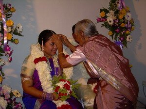 Grand aunt Velaithan blessing the couple in Malaysian Indian Engagement